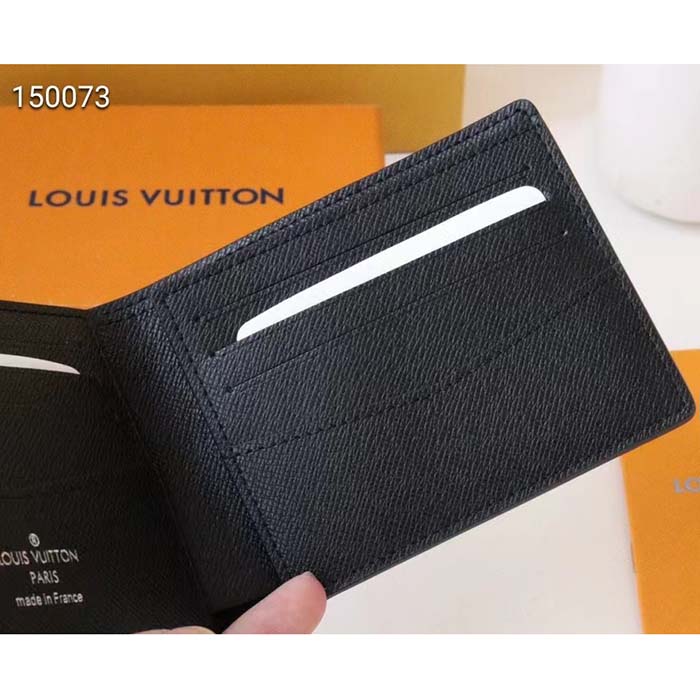 Louis VUITTON. Black taiga cowhide wallet. Three slots …