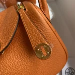 Hermes Women Lindy Mini 19 in Clemence Leather-Orange/Gold
